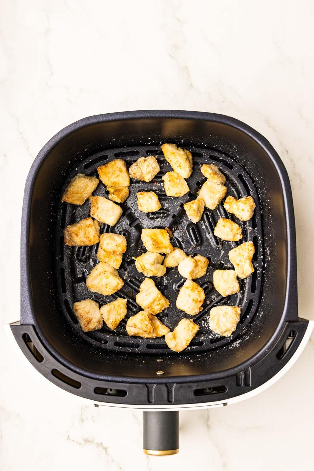air fried chicken pieces in black air fryer