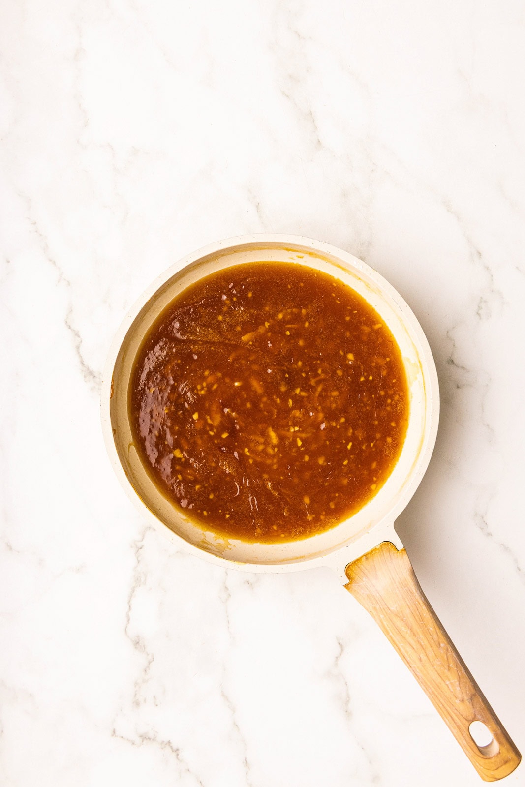 cooked orange mixture in tan skillet