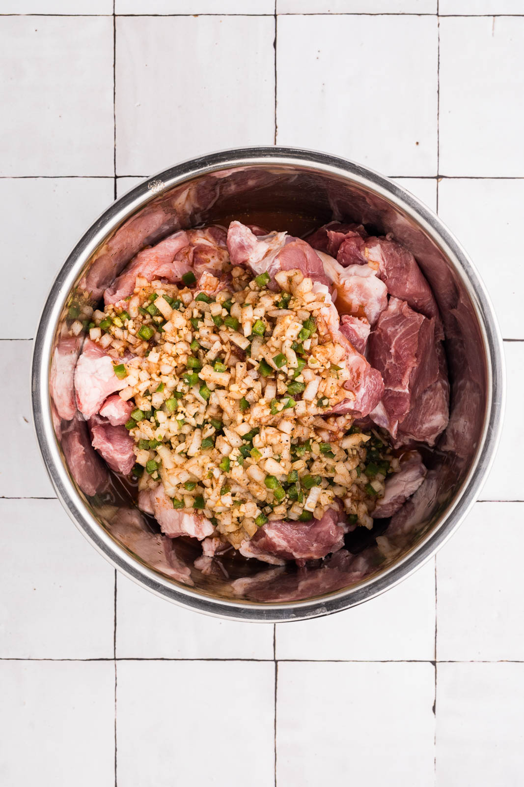 overhead view of cubed pork with remaining ingredients on top