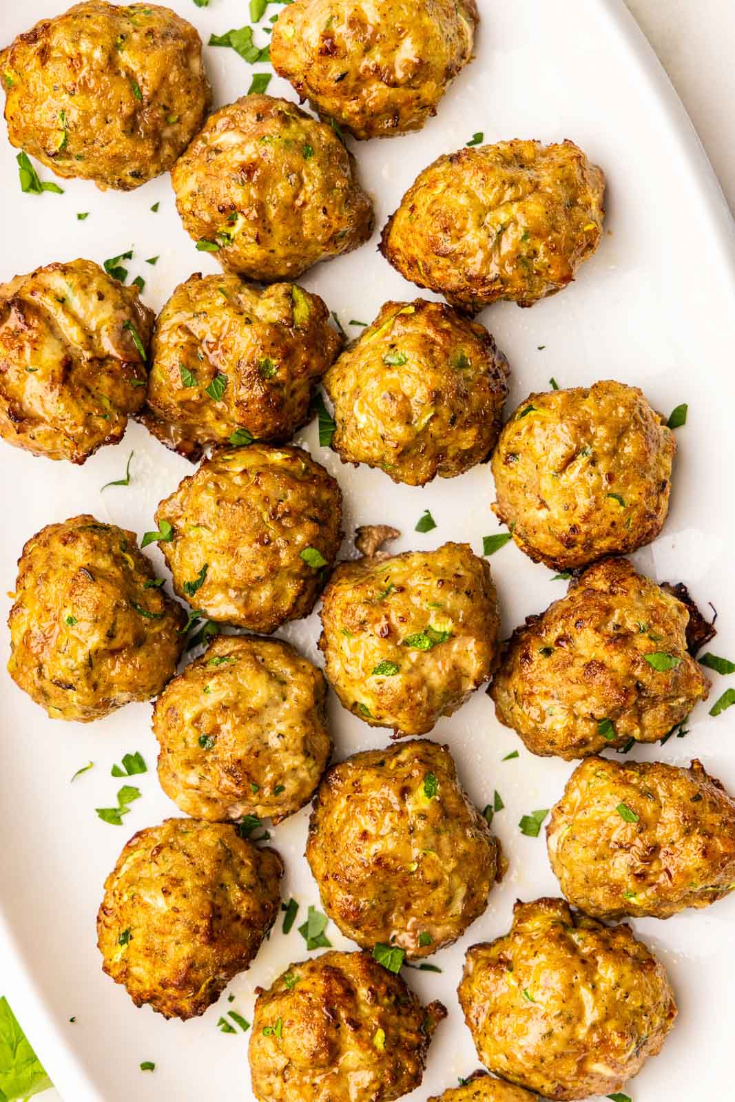 overhead view of white serving platter containing air fried turkey meatballs
