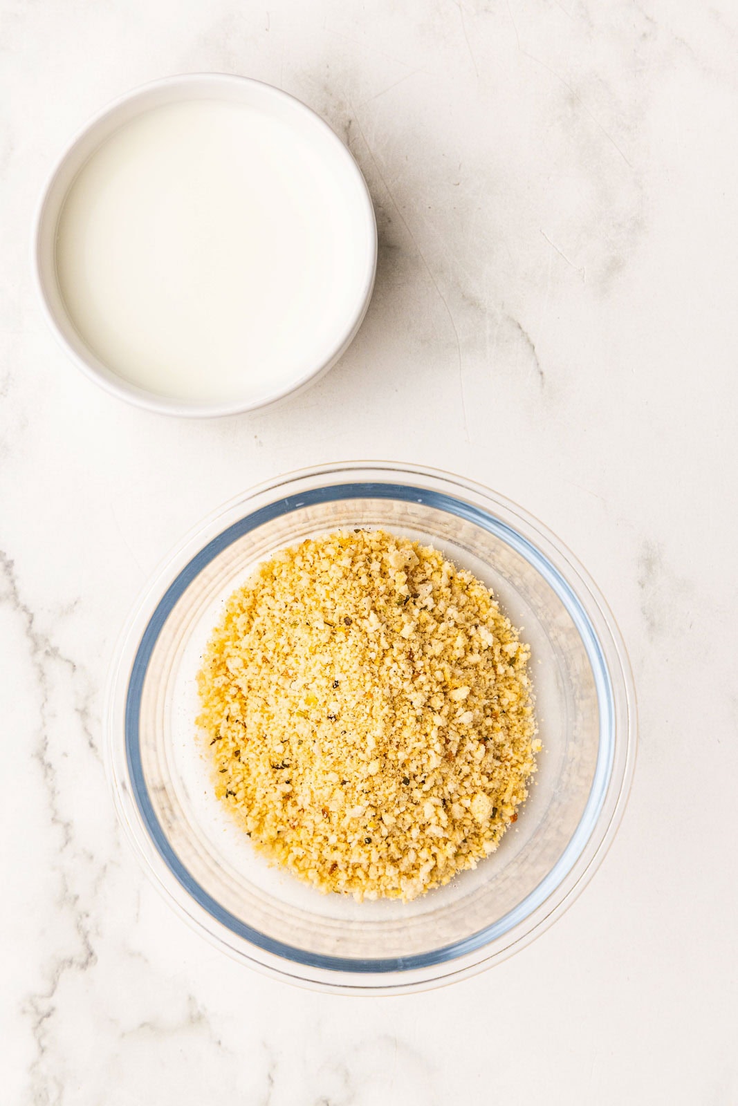 white bowl with milk and glass bowl of panko breadcrumbs