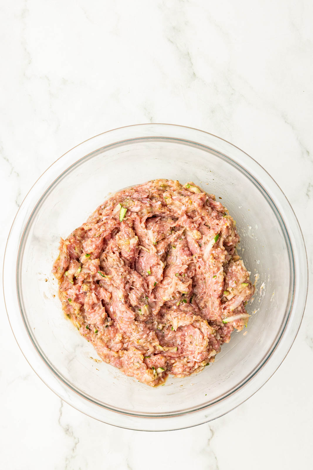 glass bowl of all turkey meatball ingredients mixed together