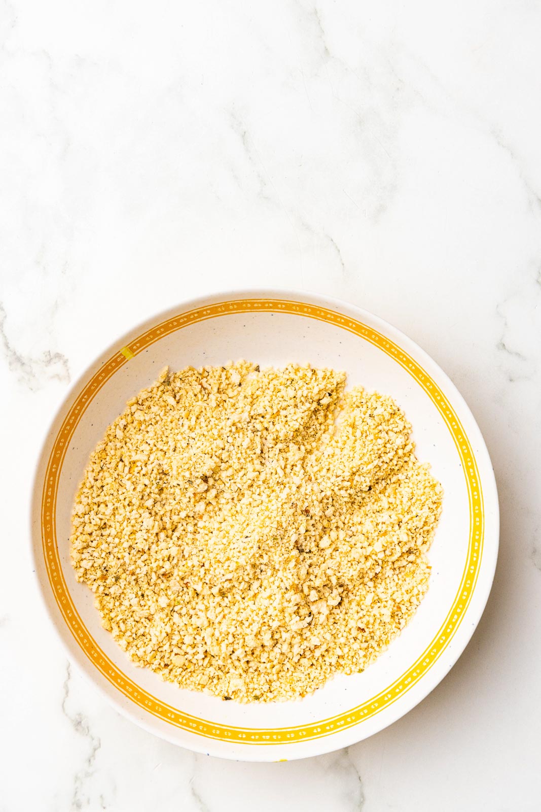 yellow rimmed white bowl of panko breadcrumbs