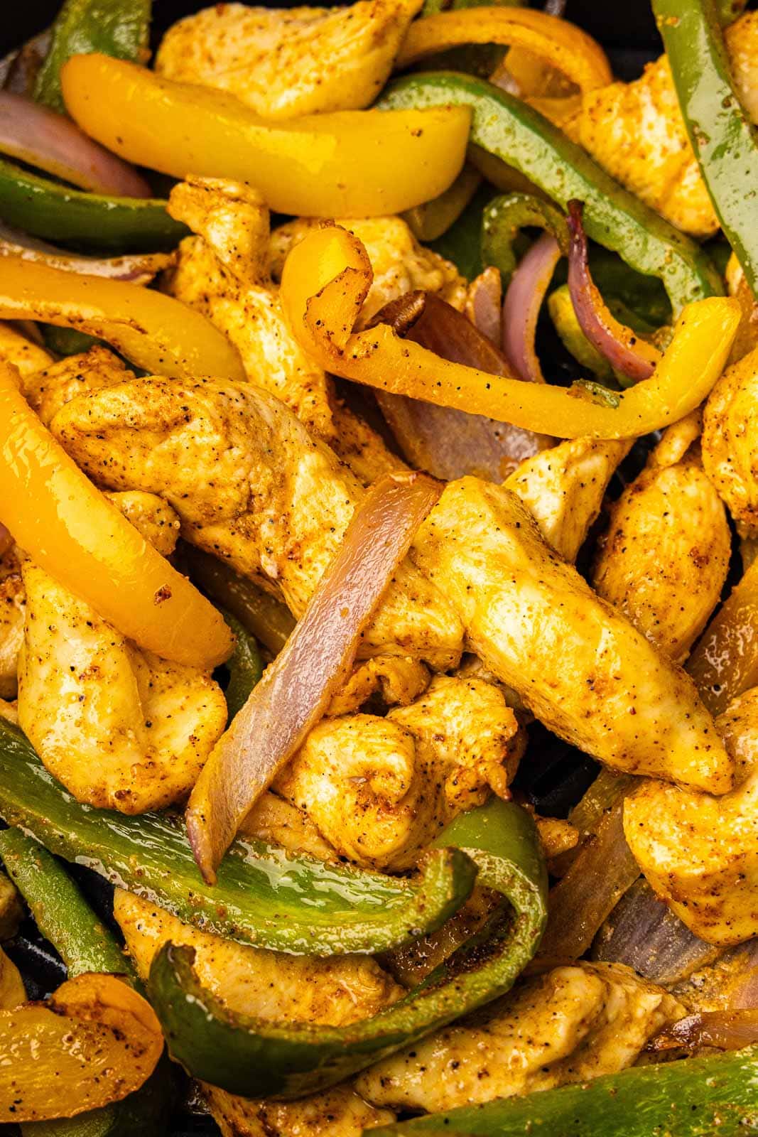 closeup of fajita mixture on wooden cutting board