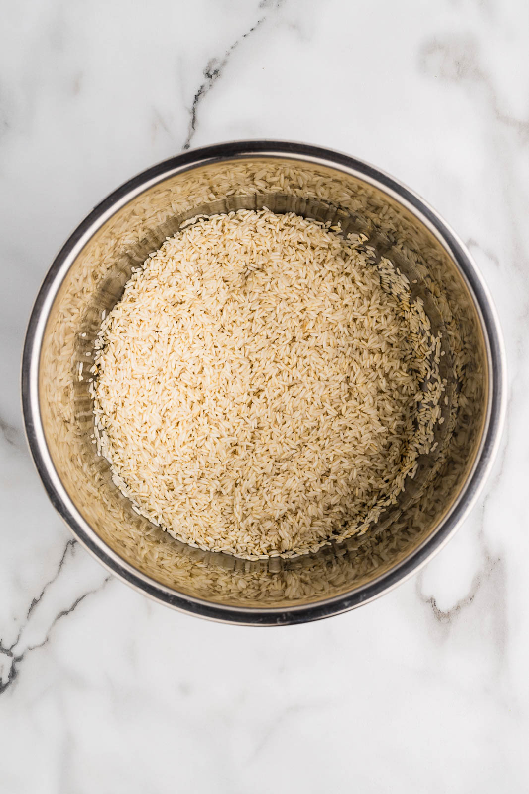 overhead view of instant pot with oil and rice