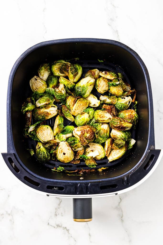 overhead view of air fryer with air fried Brussels sprouts