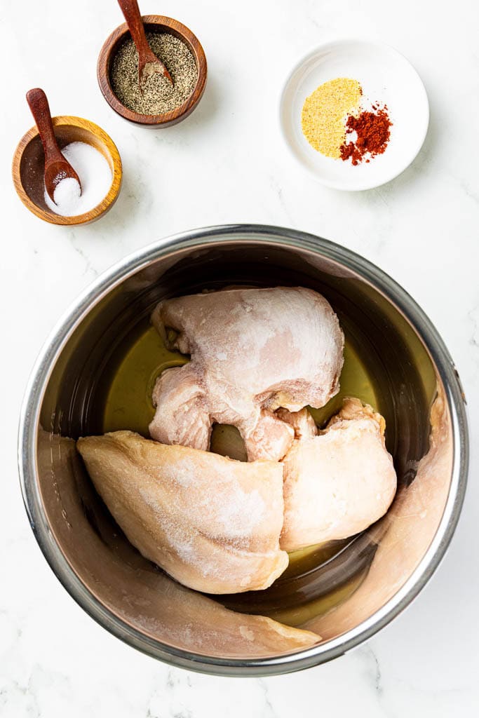 instant with with chicken broth and chicken breasts with salt, pepper and seasonings on side